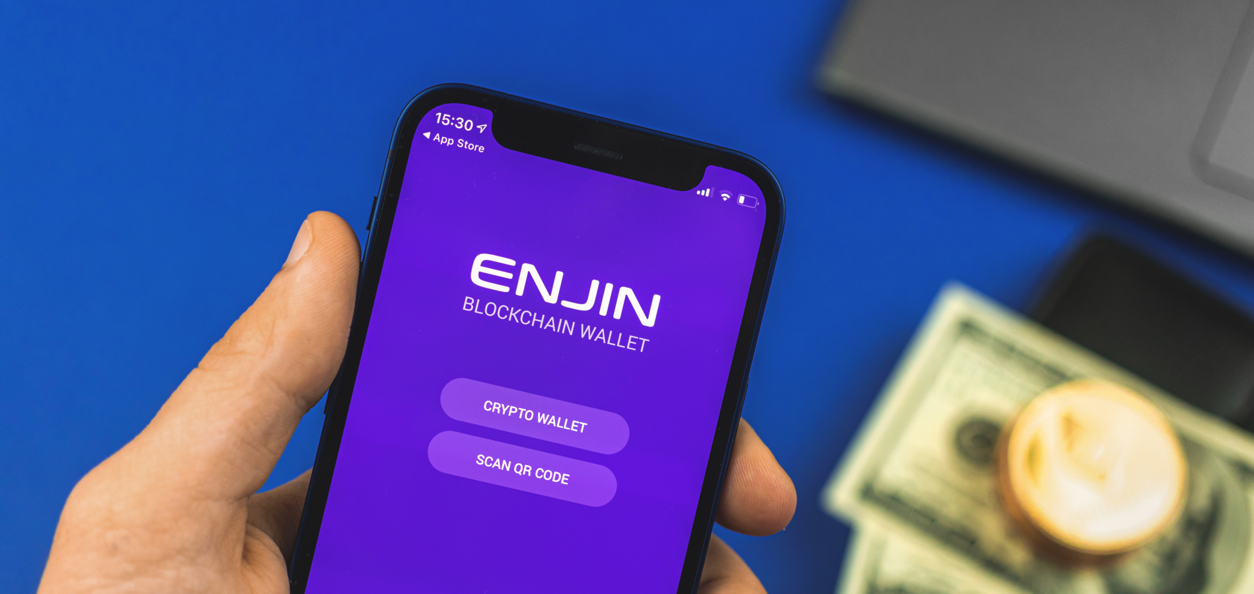 Kharkov, Ukraine - May 27, 2021: Man use mobile phone with Enjin NFT crypto blockchain wallet app, banner photo